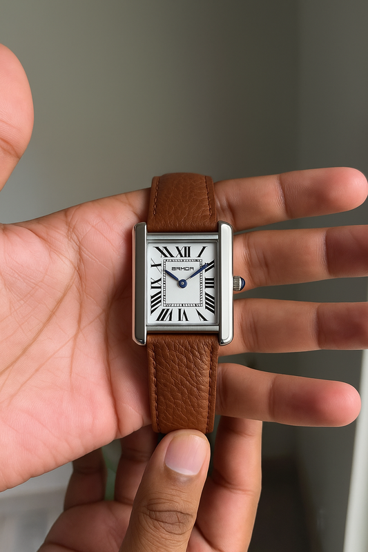 Person holding a square-shaped watch with a brown leather strap and silver case. Sanda 1108 brown leather belt.